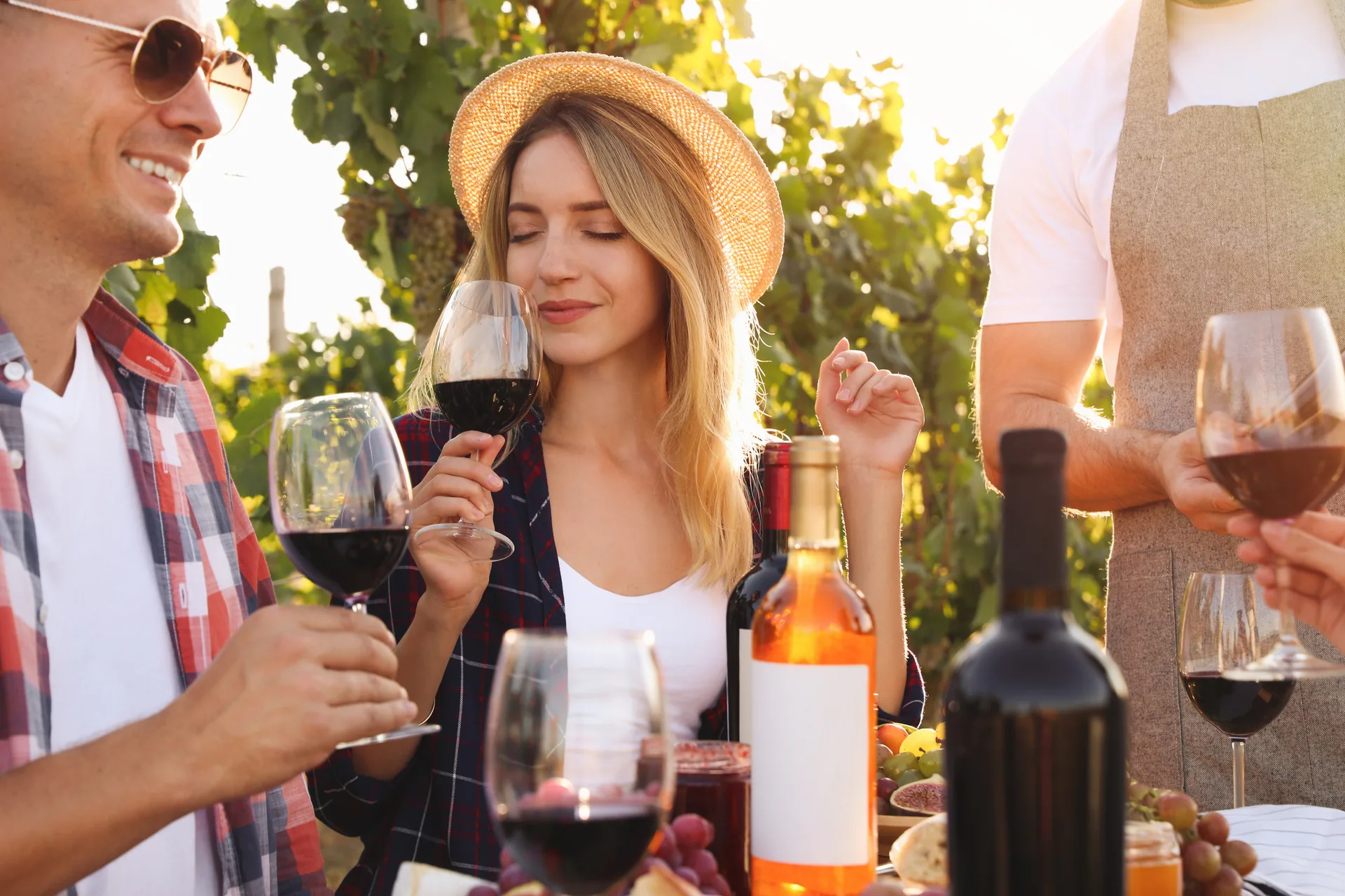 Couple enjoying wine tasting experience in scenic Napa Valley vineyard with rolling hills and grapevines in background